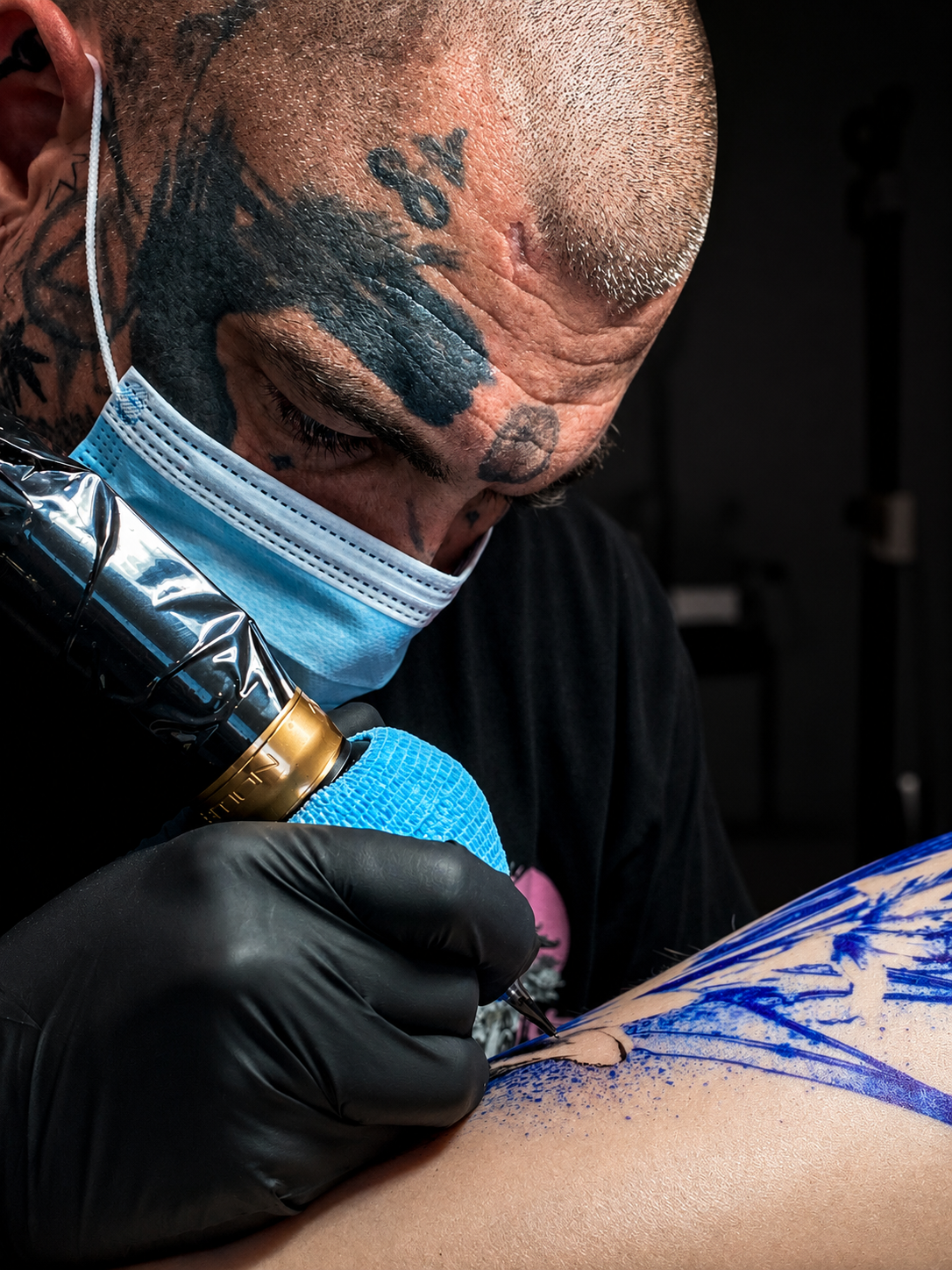Tattoo artist Y345T working on a custom piece at Hollow Oak Tattoo Co.